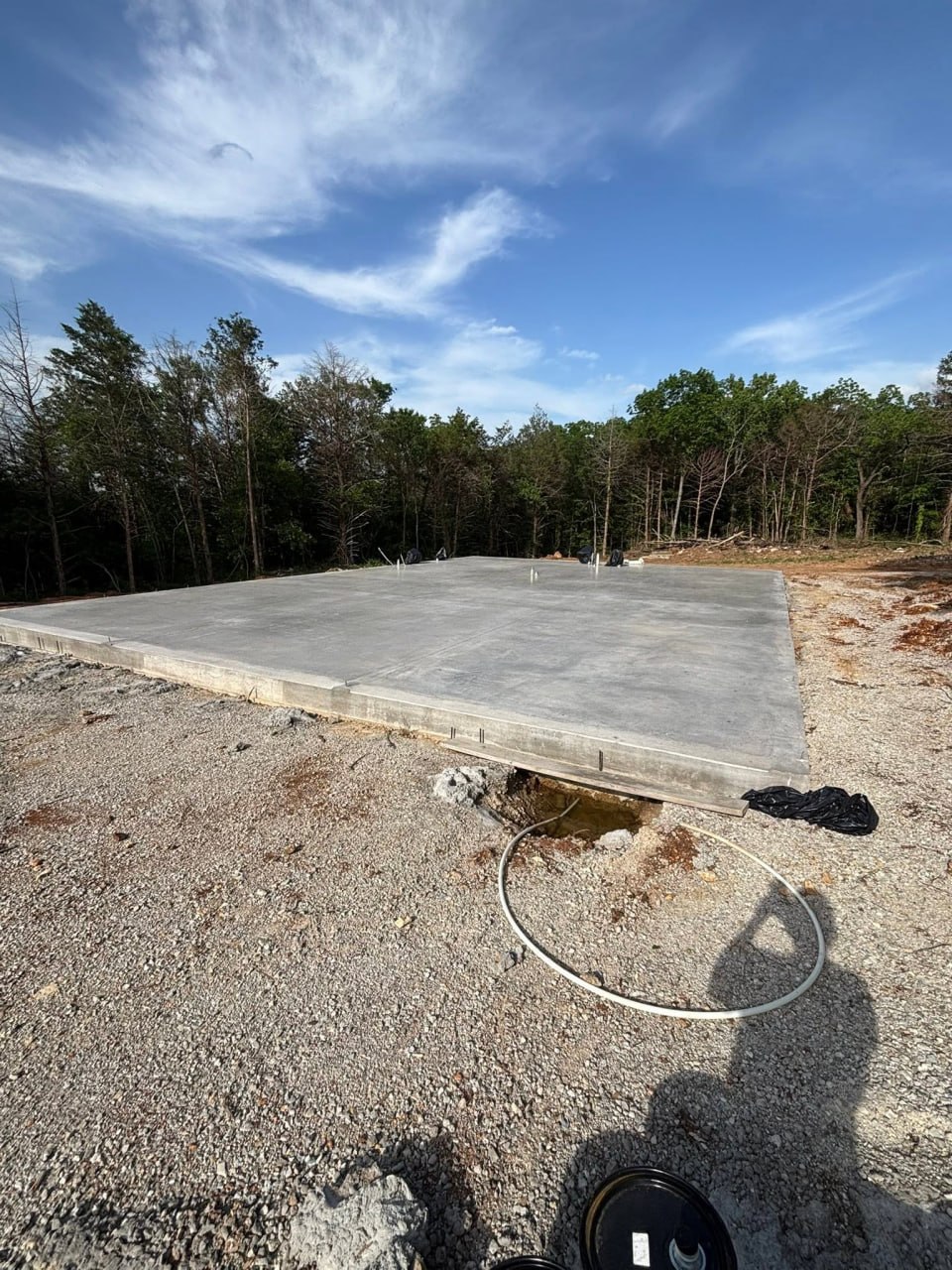 Concrete slab foundation at a wooded construction site